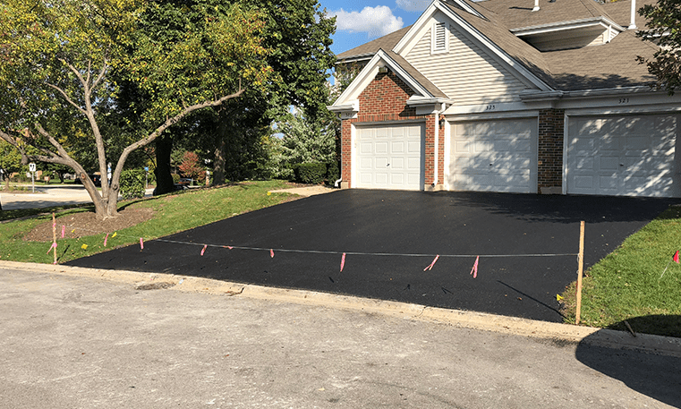 asphalt driveway in front of house