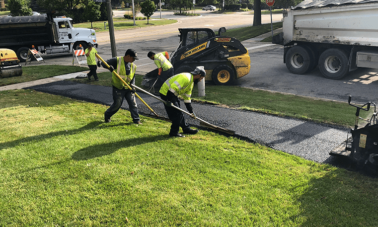 construction workers laying asphalt sidewalk