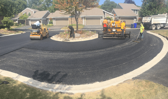construction crew paving neighborhood street