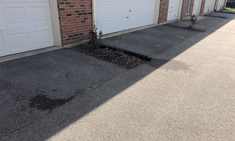 asphalt driveway in front of townhome