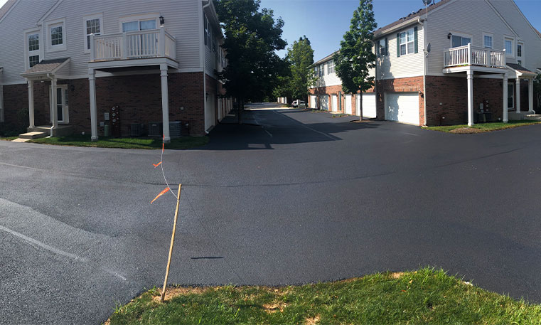 completed asphalt driveway in front of townhomes