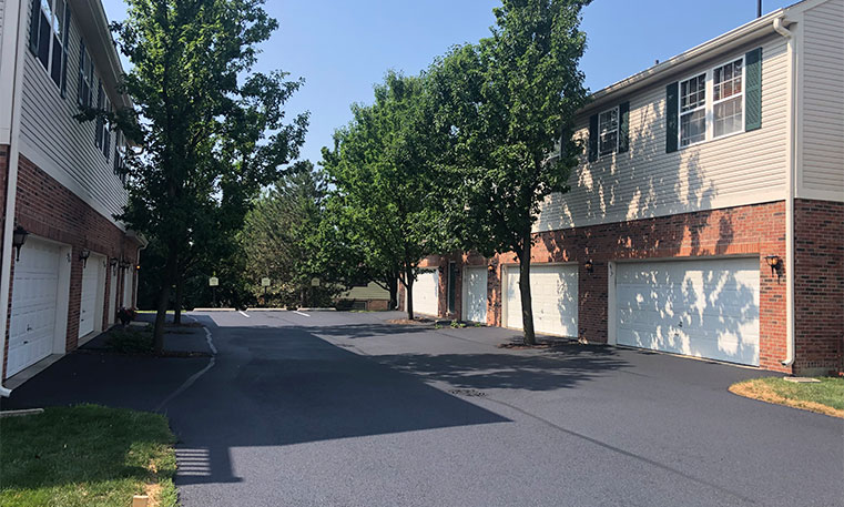 completed asphalt driveway in front of townhomes