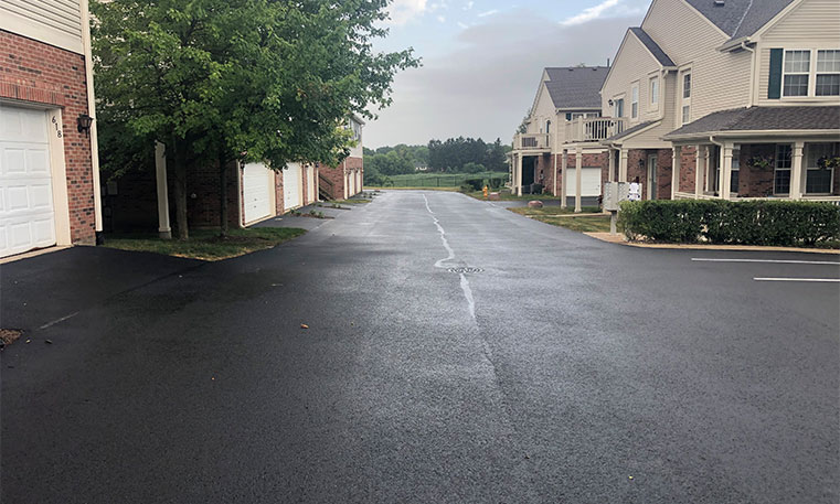 completed asphalt driveway in front of townhomes