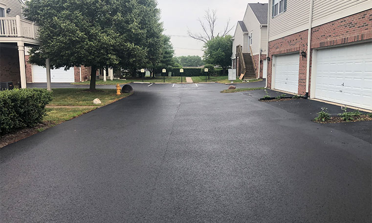 completed asphalt driveway in front of townhomes