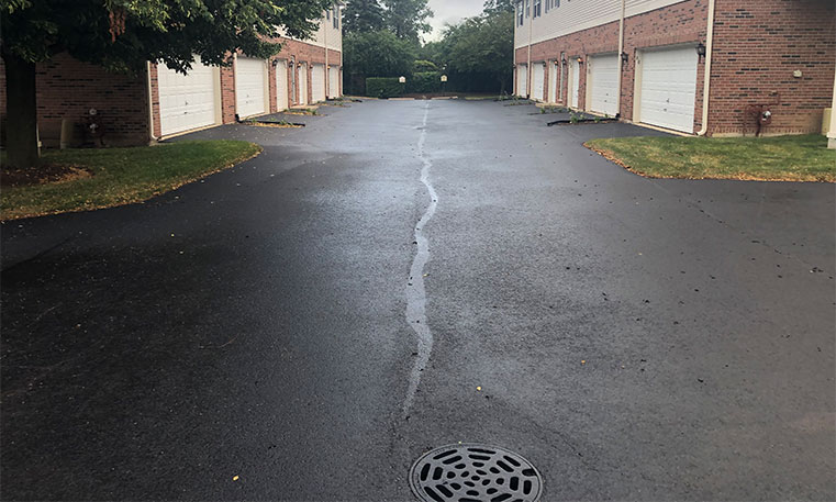 completed asphalt driveway in front of townhomes