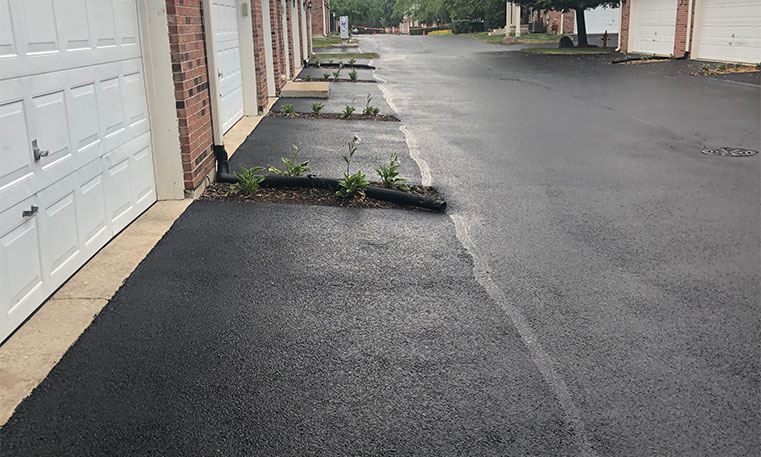 asphalt driveway in front of townhomes