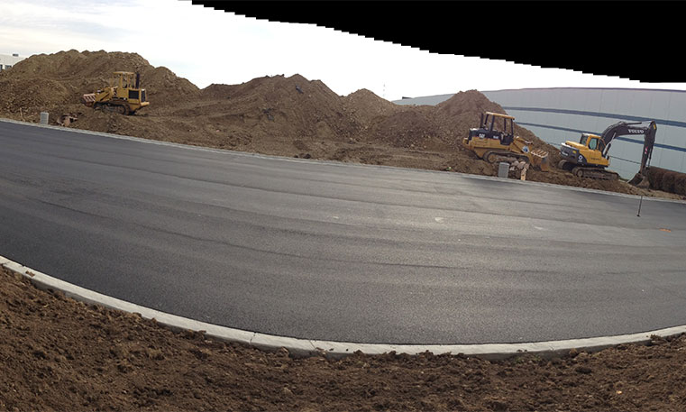 finished asphalt parking lot at construction site