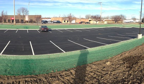 finished asphalt parking lot with green space