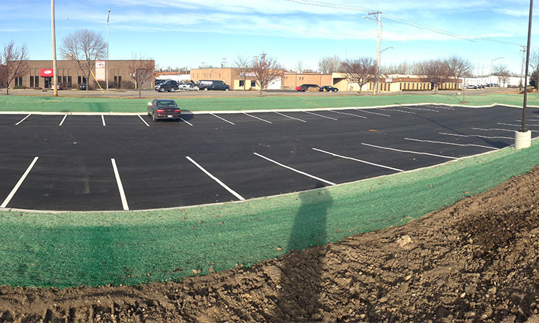 finished asphalt parking lot with green space