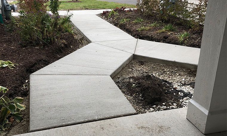 renovated sidewalk leading to street from home