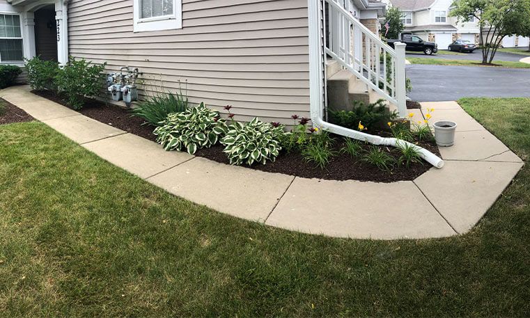 new sidewalk wrapping around side of home