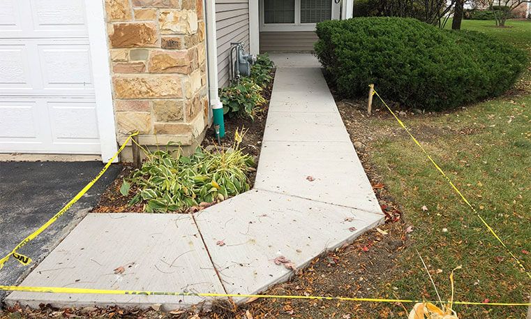 concrete sidewalk wrapping around home