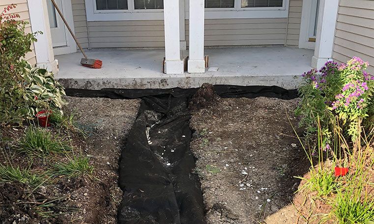 stoop and sidewalk leading up to home during renovation