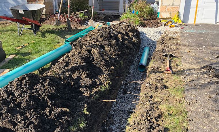 front lawn of home during drainage installation