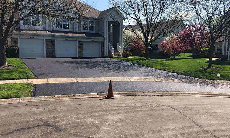 condo unit with completed asphalt driveway