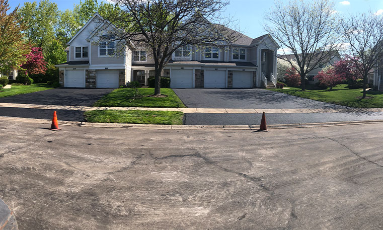 street view of condo unit with completed driveway