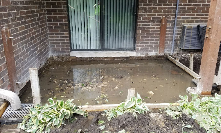 damaged patio concrete in front of home