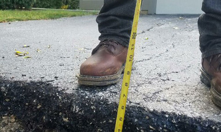 twin brothers contractor measuring asphalt