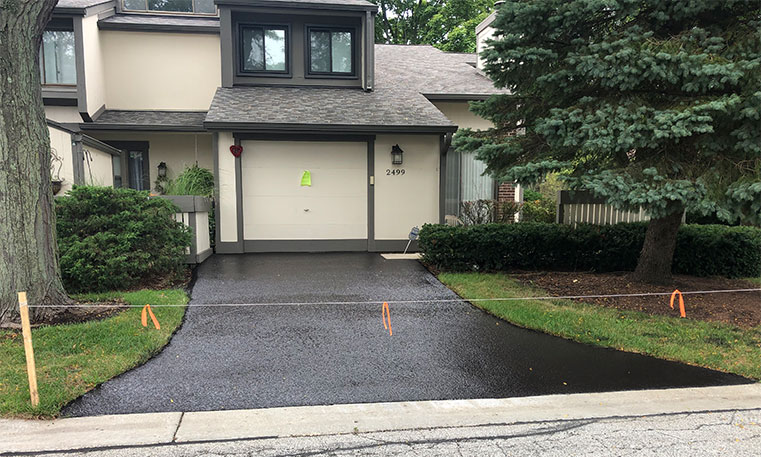 front view of home and driveway after asphalt replacement