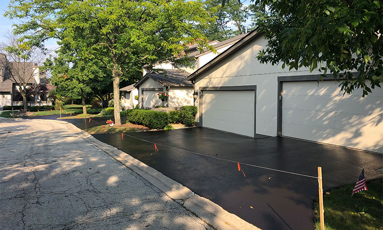 side view of finished driveway after asphalt replacement