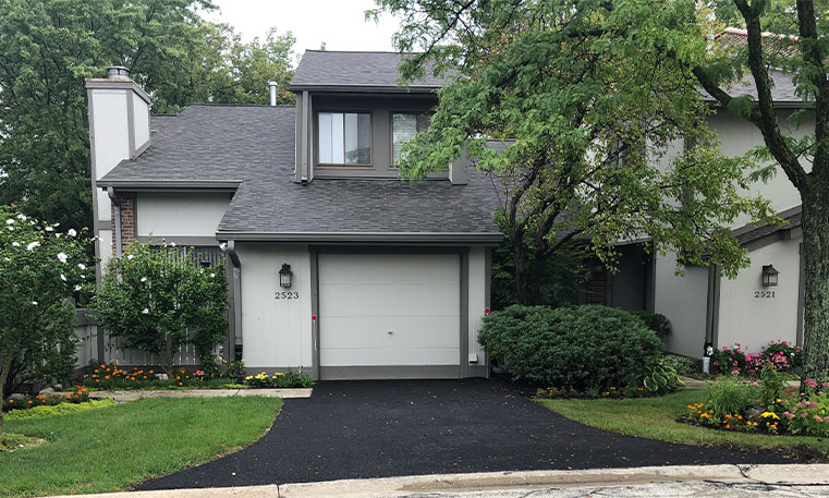 front view of home and driveway after asphalt replacement