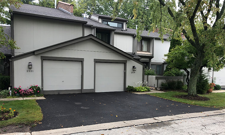 front view of home and driveway after asphalt replacement