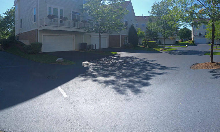 finished asphalt driveway in front of townhome