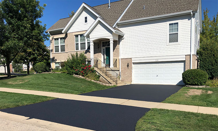 finished asphalt driveway in front of townhome