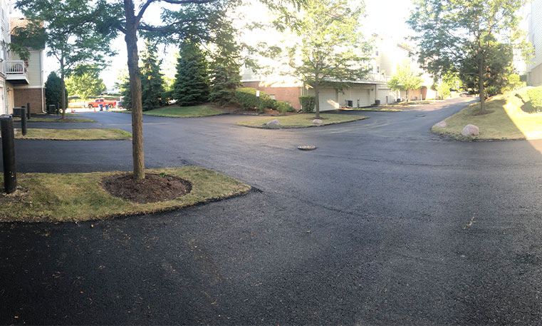 townhome driveway and parking space after asphalt replacement