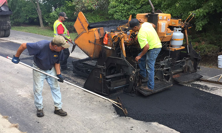 twin bros. team asphalt patching a damaged concrete surface