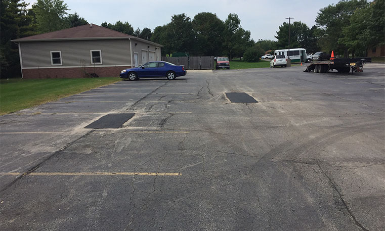 damaged parking lot pavement