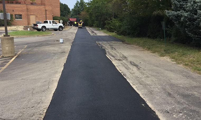 paved asphalt patch in parking lot