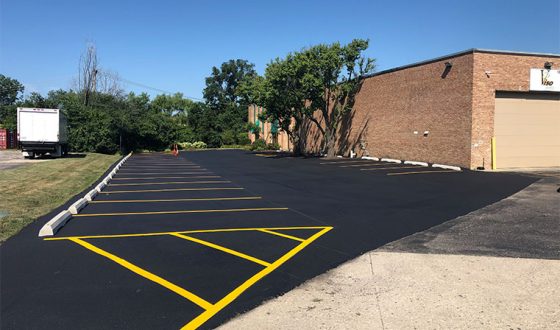 finished asphalt parking lot with lot markings