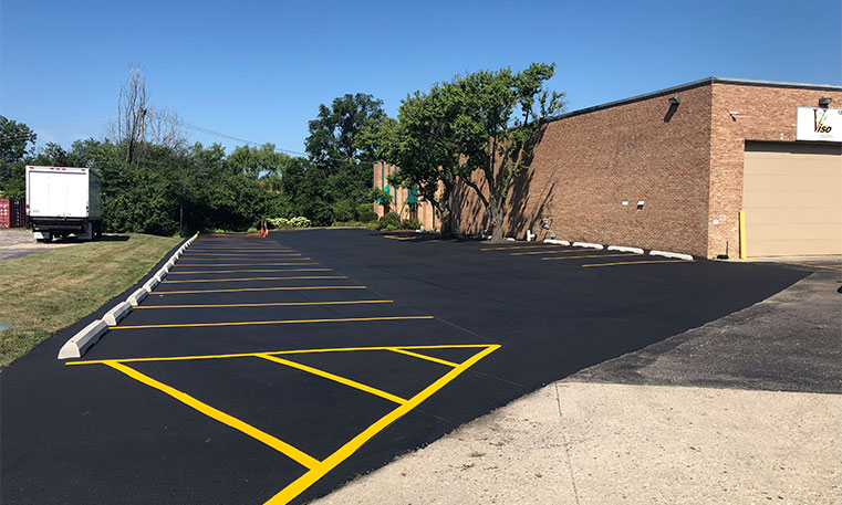 finished asphalt parking lot with lot markings