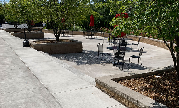 finished concrete and walkway in outdoor lounge area