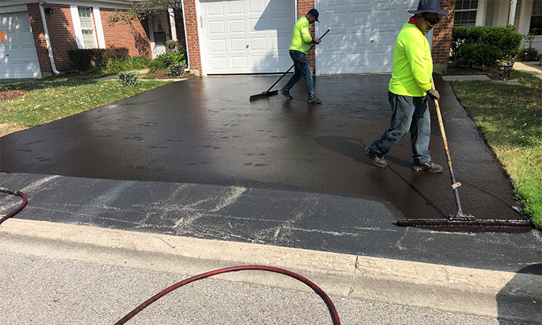 twin bros. paving team sealcoating home driveway