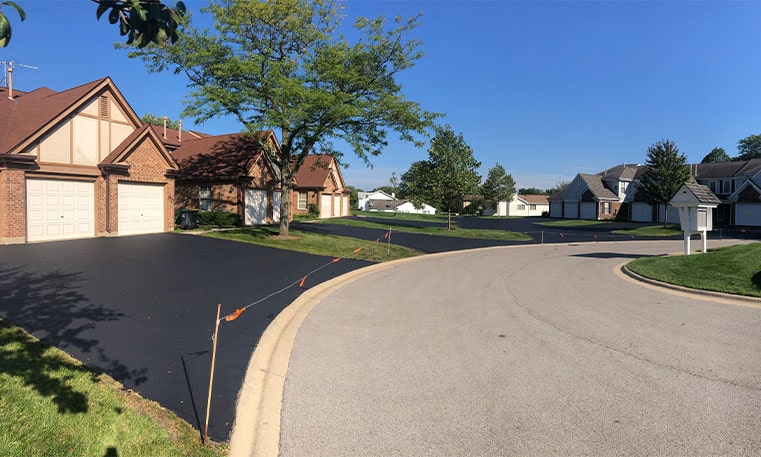 side view of home driveway after sealcoating project