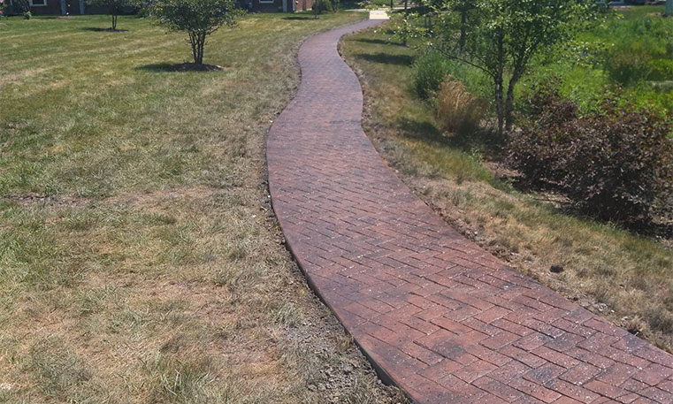 paved walkway outside of condo buildings